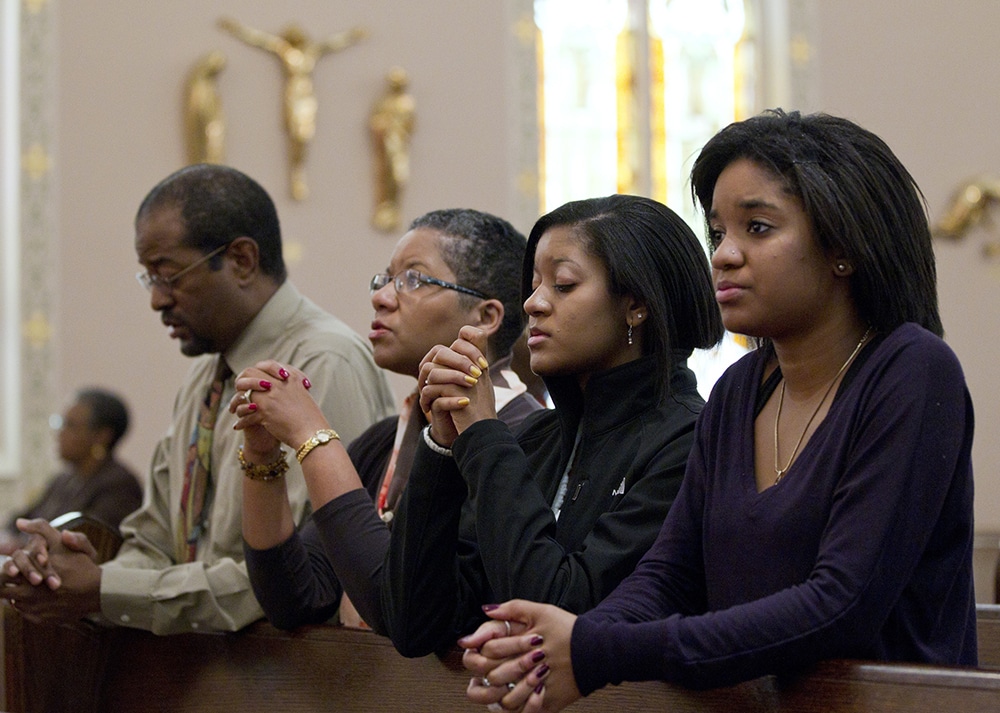 black people praying together