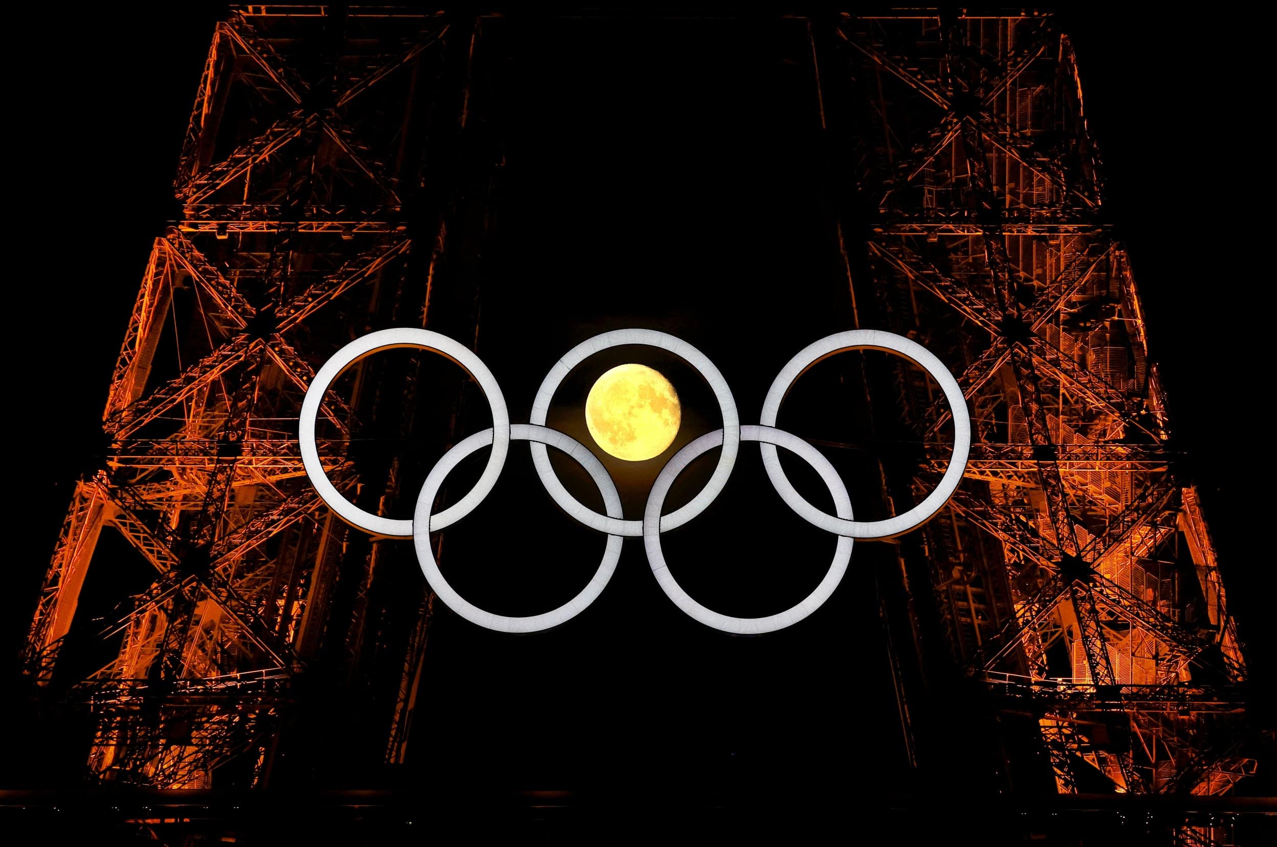 The moon is pictured with the Olympic rings on the Eiffel Tower ahead the Paris 2024 Olympic and Paralympic Games in Paris July 23, 2024.